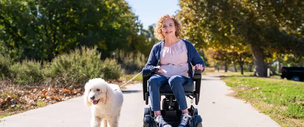Patient in motorized wheelchair with dog